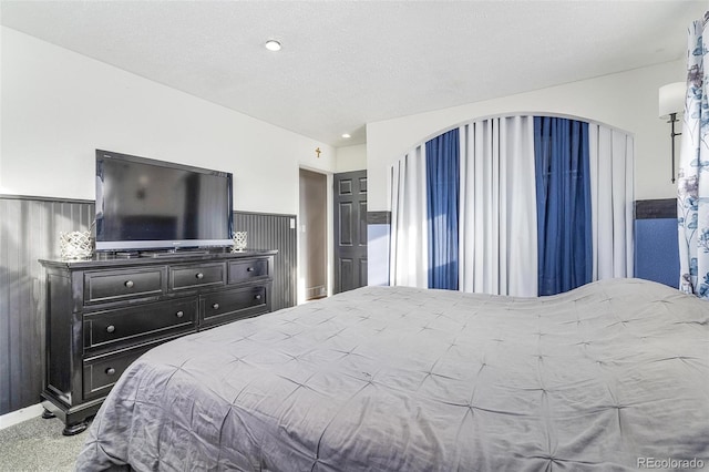 carpeted bedroom with a textured ceiling