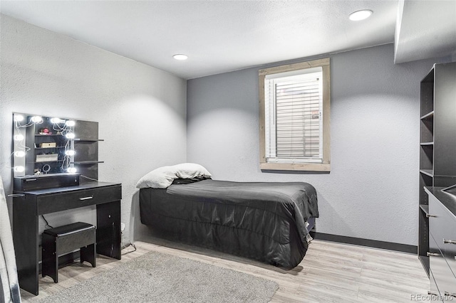 bedroom with light wood-type flooring