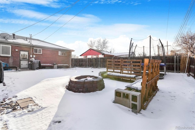 yard covered in snow with an outdoor fire pit