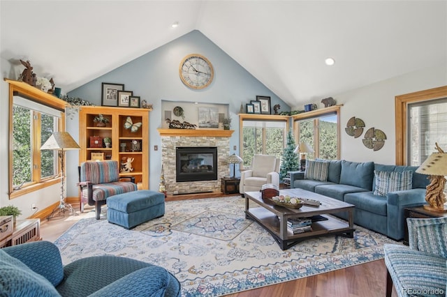30206 Telluride Ln, Evergreen, CO 80439 - living room featuring healthy amount of natural light, lofted ceiling, a fireplace, wood finished floors, and recessed lighting