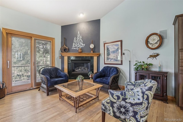 30206 Telluride Ln, Evergreen, CO 80439 - living room featuring a tiled fireplace and light wood finished floors