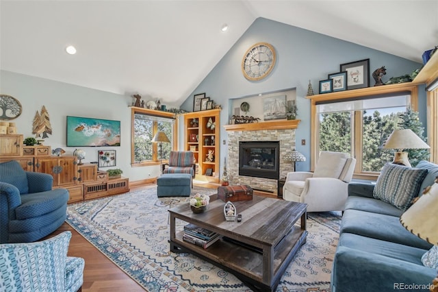 30206 Telluride Ln, Evergreen, CO 80439 - living area featuring wood finished floors, a stone fireplace, high vaulted ceiling, and recessed lighting