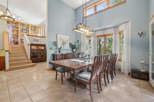30206 Telluride Ln, Evergreen, CO 80439 - dining room featuring a chandelier, a towering ceiling, tile patterned floors, and stairway