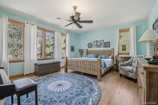 30206 Telluride Ln, Evergreen, CO 80439 - bedroom with multiple windows, light wood finished floors, and a ceiling fan