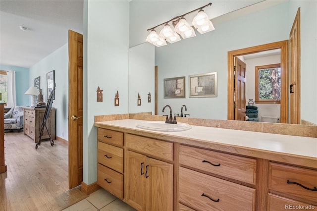 30206 Telluride Ln, Evergreen, CO 80439 - full bathroom featuring vanity, connected bathroom, and wood finished floors