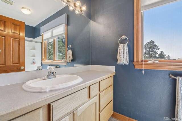 30206 Telluride Ln, Evergreen, CO 80439 - bathroom with vanity and a shower with door