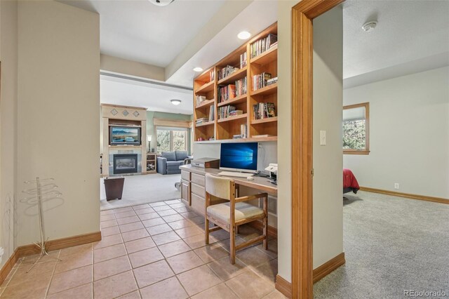 30206 Telluride Ln, Evergreen, CO 80439 - office space featuring light carpet, a glass covered fireplace, recessed lighting, and light tile patterned floors