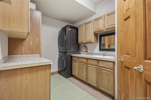 30206 Telluride Ln, Evergreen, CO 80439 - kitchen featuring stacked washing machine and dryer, light countertops, light wood finished floors, and light brown cabinetry