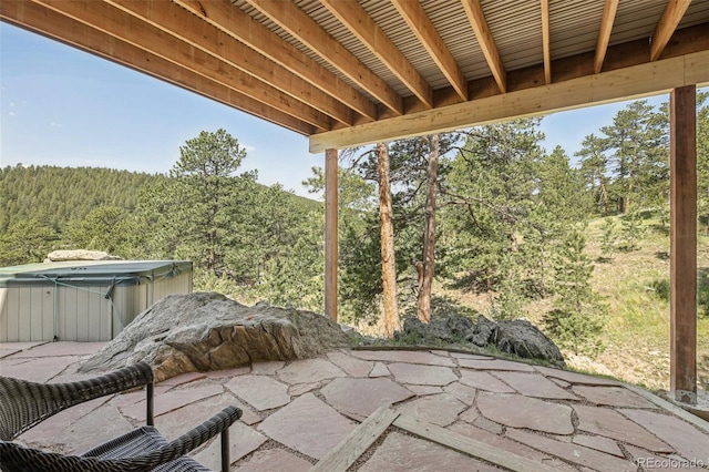 30206 Telluride Ln, Evergreen, CO 80439 - view of patio / terrace featuring a hot tub and a forest view