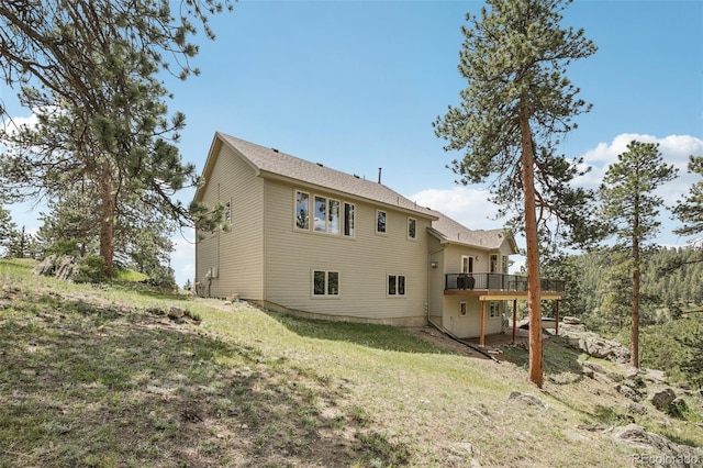 30206 Telluride Ln, Evergreen, CO 80439 - rear view of house featuring a deck and a lawn