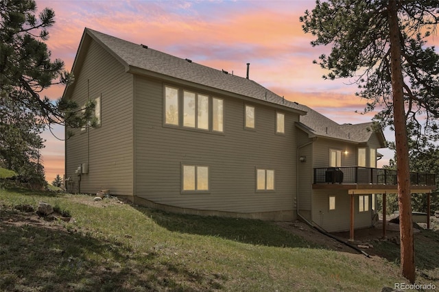 30206 Telluride Ln, Evergreen, CO 80439 - view of property exterior featuring a deck, a lawn, and roof with shingles
