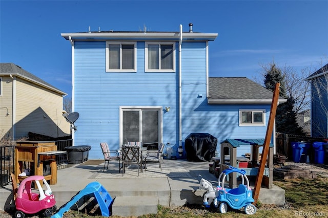 back of property featuring fence and a patio area