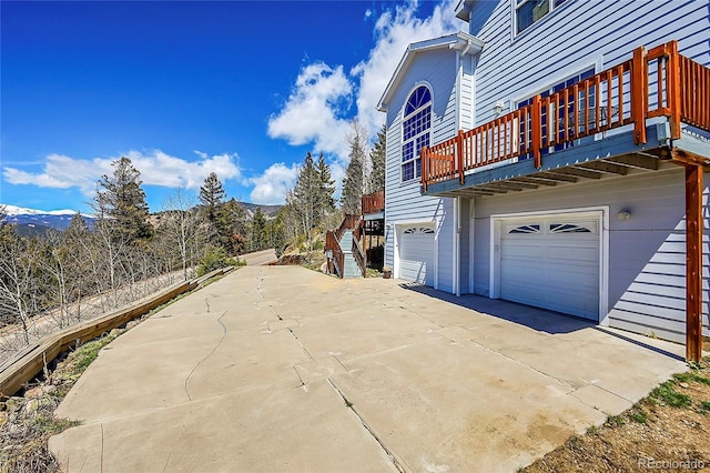11770 Leavenworth Dr, Conifer, CO 80433 - view of side of property featuring driveway and a garage