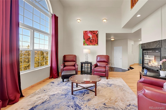 11770 Leavenworth Dr, Conifer, CO 80433 - living room with a multi sided fireplace, wood finished floors, baseboards, and recessed lighting