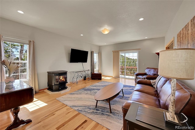 11770 Leavenworth Dr, Conifer, CO 80433 - living room featuring a wood stove, light wood finished floors, and recessed lighting