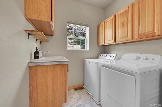 11770 Leavenworth Dr, Conifer, CO 80433 - laundry room with washer and dryer, a sink, cabinet space, visible vents, and marble finish floor