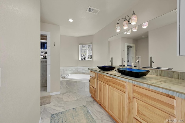 11770 Leavenworth Dr, Conifer, CO 80433 - full bath featuring a sink, marble finish floor, a bath, and visible vents