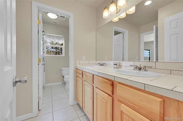 11770 Leavenworth Dr, Conifer, CO 80433 - bathroom with toilet, tile patterned flooring, baseboards, and a sink