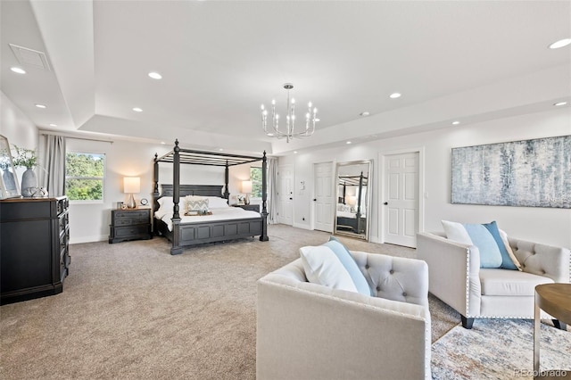 carpeted bedroom featuring a tray ceiling and an inviting chandelier