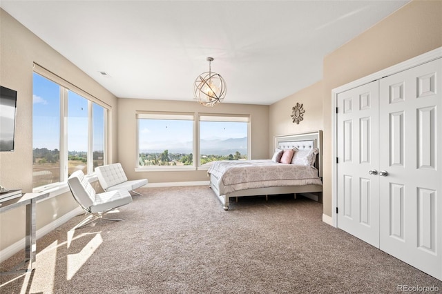 bedroom featuring carpet flooring and an inviting chandelier