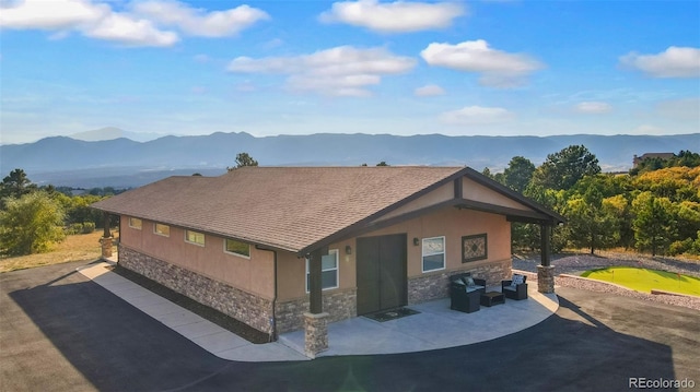 exterior space with a mountain view and a patio area