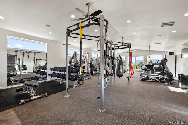 workout area with lofted ceiling, ceiling fan, plenty of natural light, and a textured ceiling