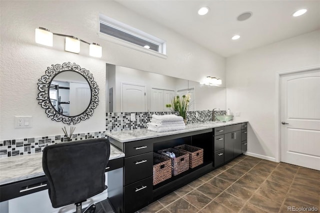 bathroom with decorative backsplash and vanity