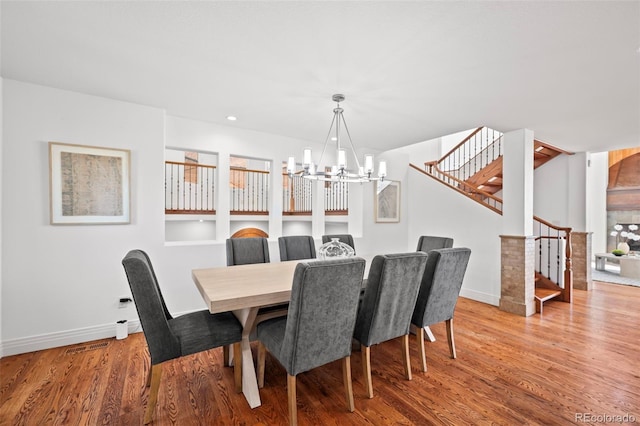 dining area with an inviting chandelier and light wood-type flooring