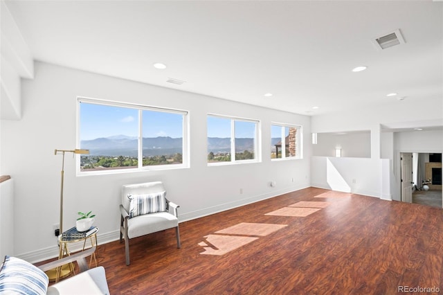 living room with a mountain view and dark hardwood / wood-style floors