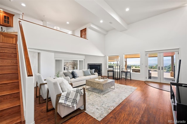 living room with a high ceiling, french doors, and dark hardwood / wood-style flooring