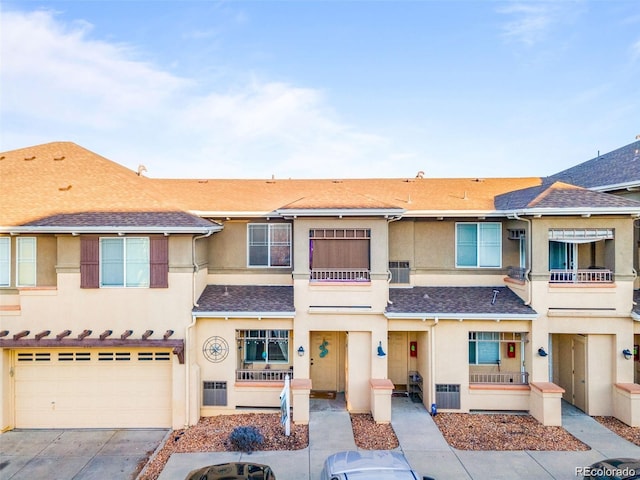 833 E 98th Ave Unit 204, Thornton, CO 80229 - townhome / multi-family property with stucco siding, driveway, an attached garage, and a balcony