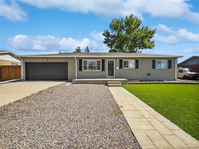 ranch-style home with a garage and a front lawn