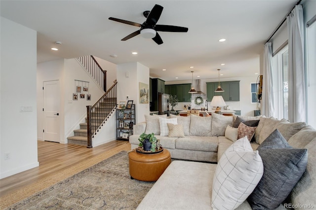 living room with light wood-type flooring and ceiling fan