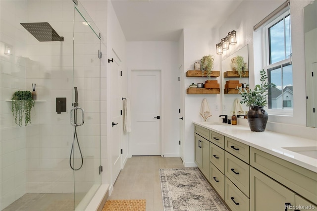 bathroom with tile patterned flooring, a shower with shower door, and vanity