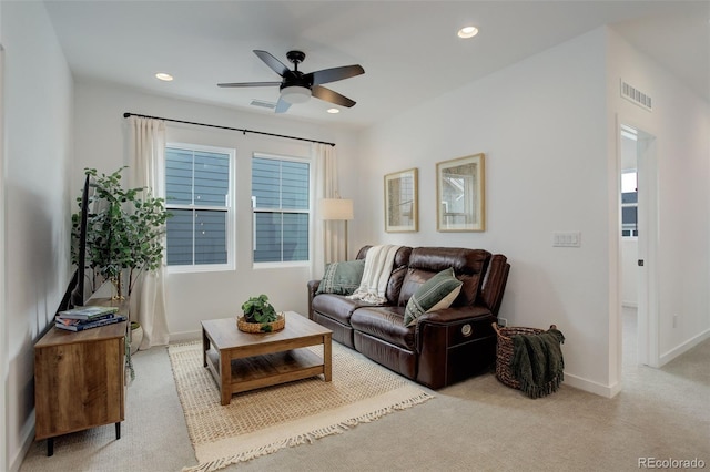 carpeted living room with ceiling fan and plenty of natural light