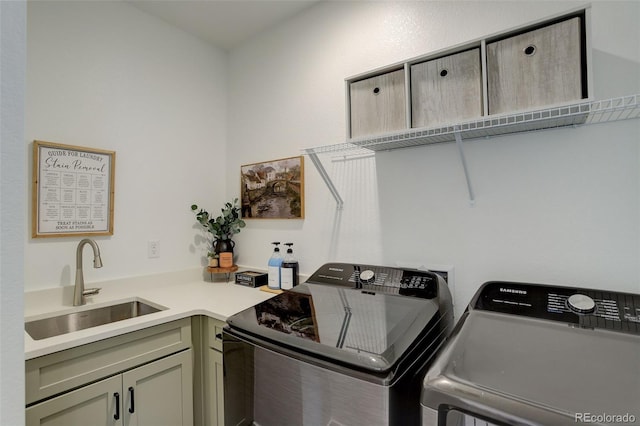 laundry room featuring sink, cabinets, and washing machine and dryer