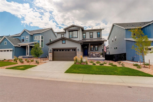 craftsman inspired home with covered porch, a front yard, and a garage