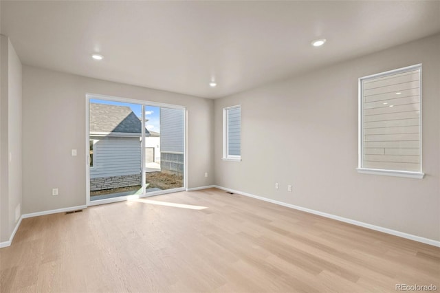 empty room with light hardwood / wood-style flooring