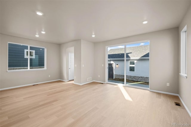 unfurnished room with light hardwood / wood-style floors