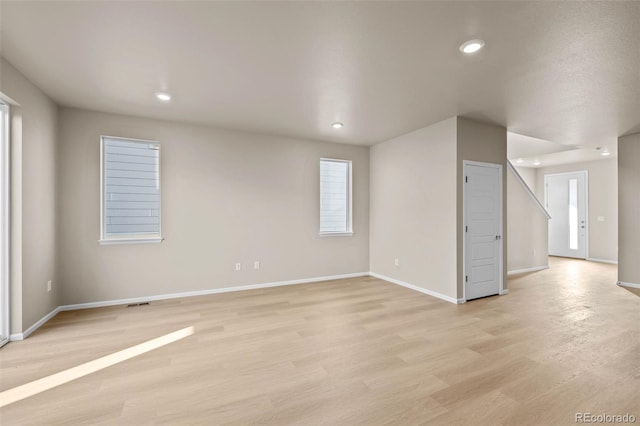 unfurnished room with a wealth of natural light and light wood-type flooring