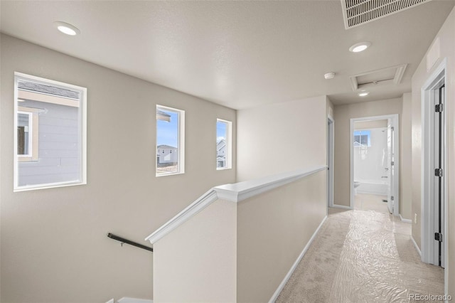 hallway with light colored carpet