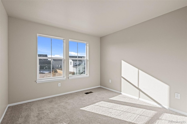 spare room featuring light colored carpet