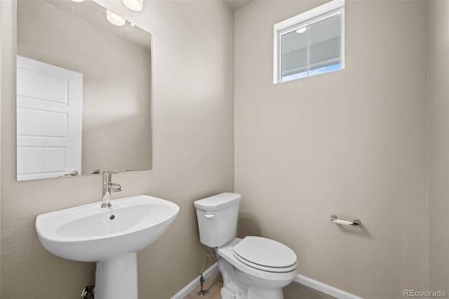 bathroom featuring toilet and sink