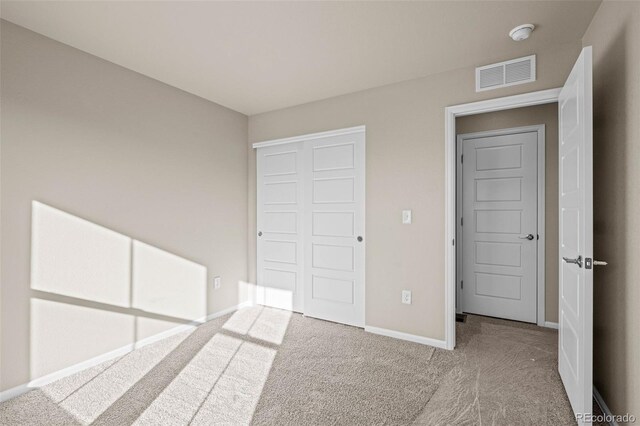 unfurnished bedroom with a closet and carpet