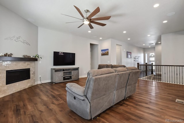 12938 Bridge View Ln, Parker, CO 80134 - living room with a ceiling fan, dark wood-type flooring, recessed lighting, a glass covered fireplace, and baseboards