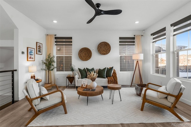 living area featuring light hardwood / wood-style flooring and ceiling fan