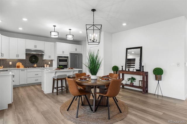 dining room featuring a chandelier and light wood-type flooring