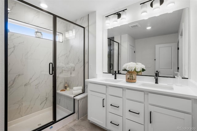 bathroom featuring vanity, a shower with shower door, and tile patterned flooring