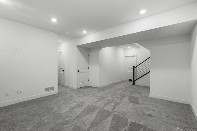 basement featuring light carpet