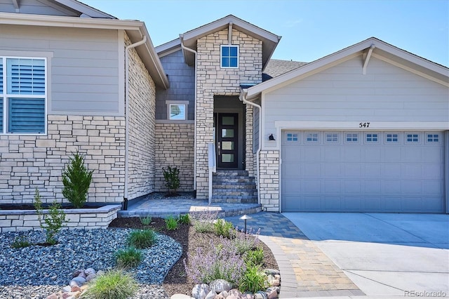 547 Scrubjay Cir, Castle Rock, CO 80104 - view of front facade featuring stone siding, an attached garage, and driveway